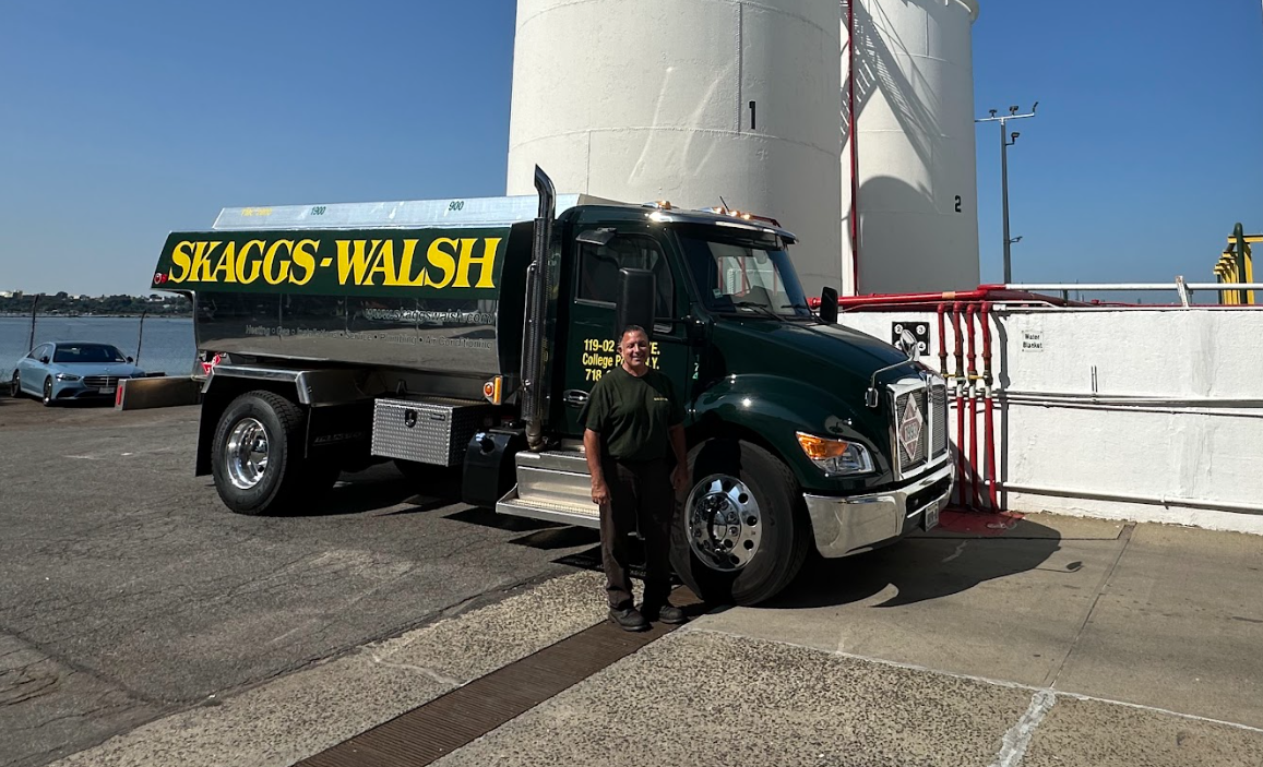 A Skaggs-Walsh delivery truck and one of our experienced drivers are ready for heating oil delivery in Queens.
